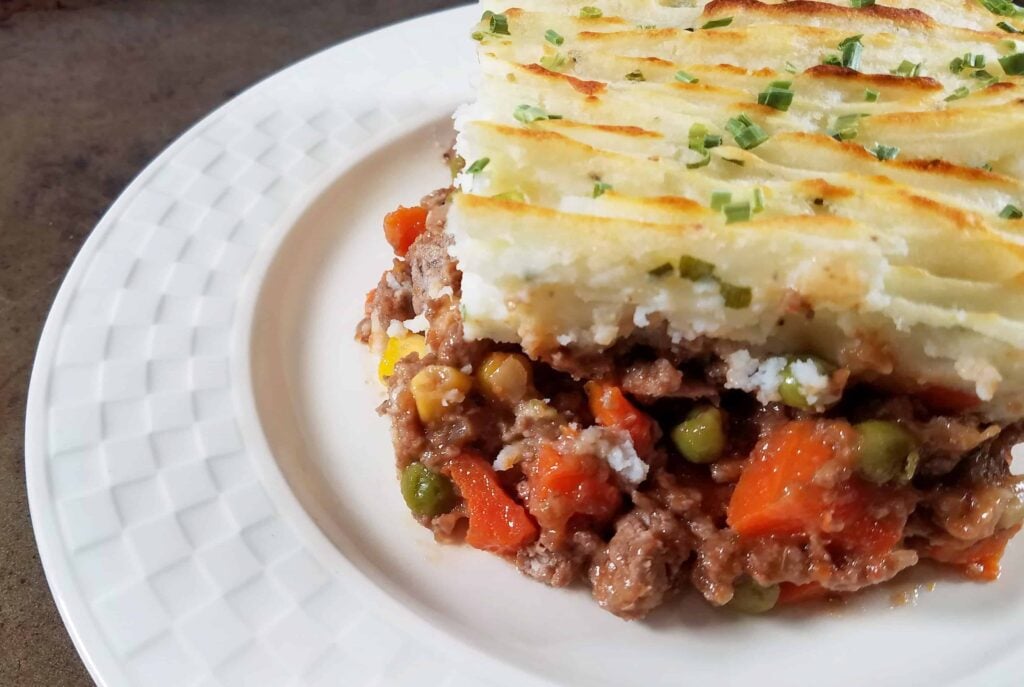 A close up of shepherd's pie on a plate.